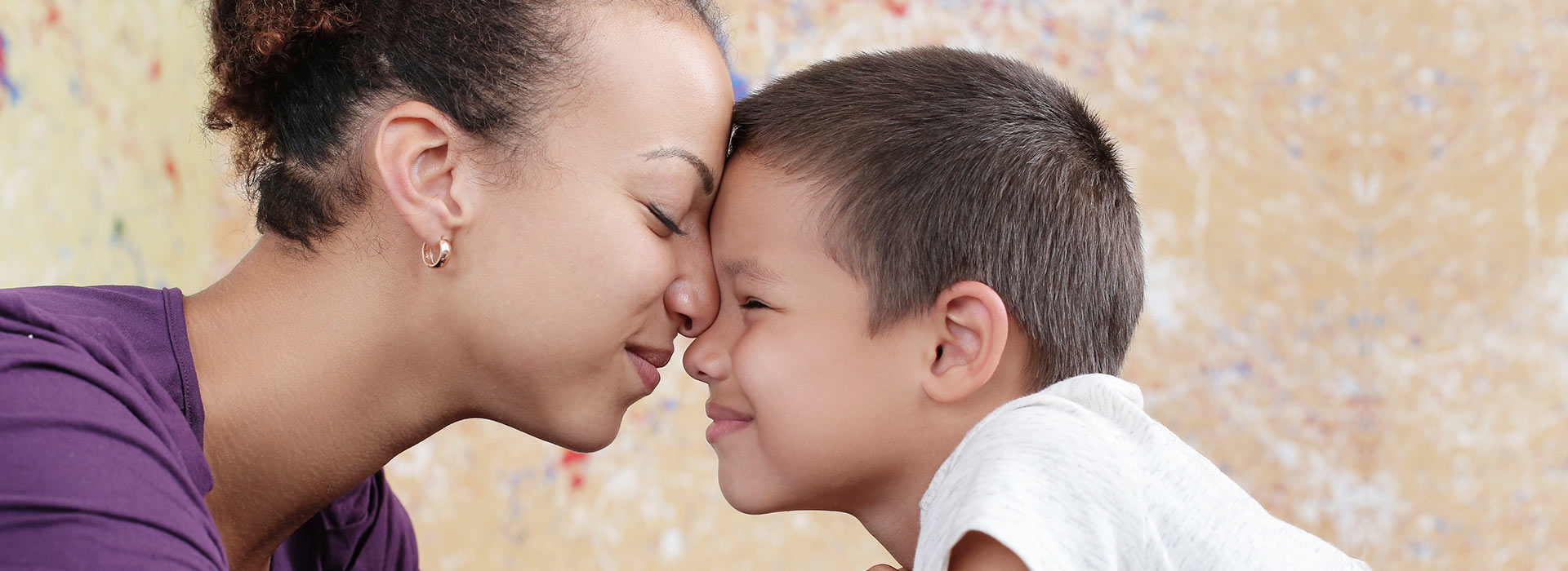 Parent and child nose-to-nose, smiling