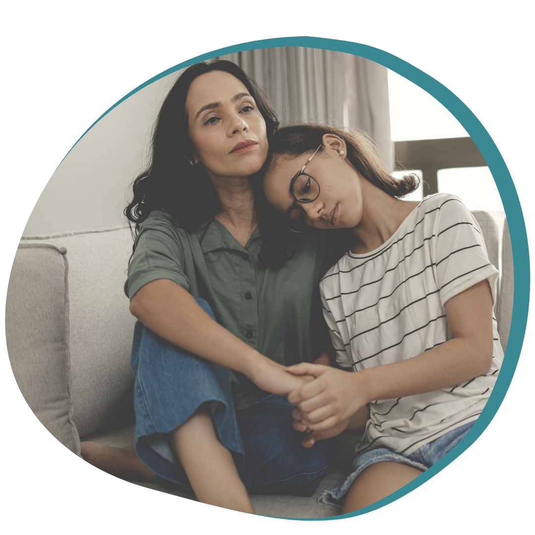 Mother comforts Daughter on Couch