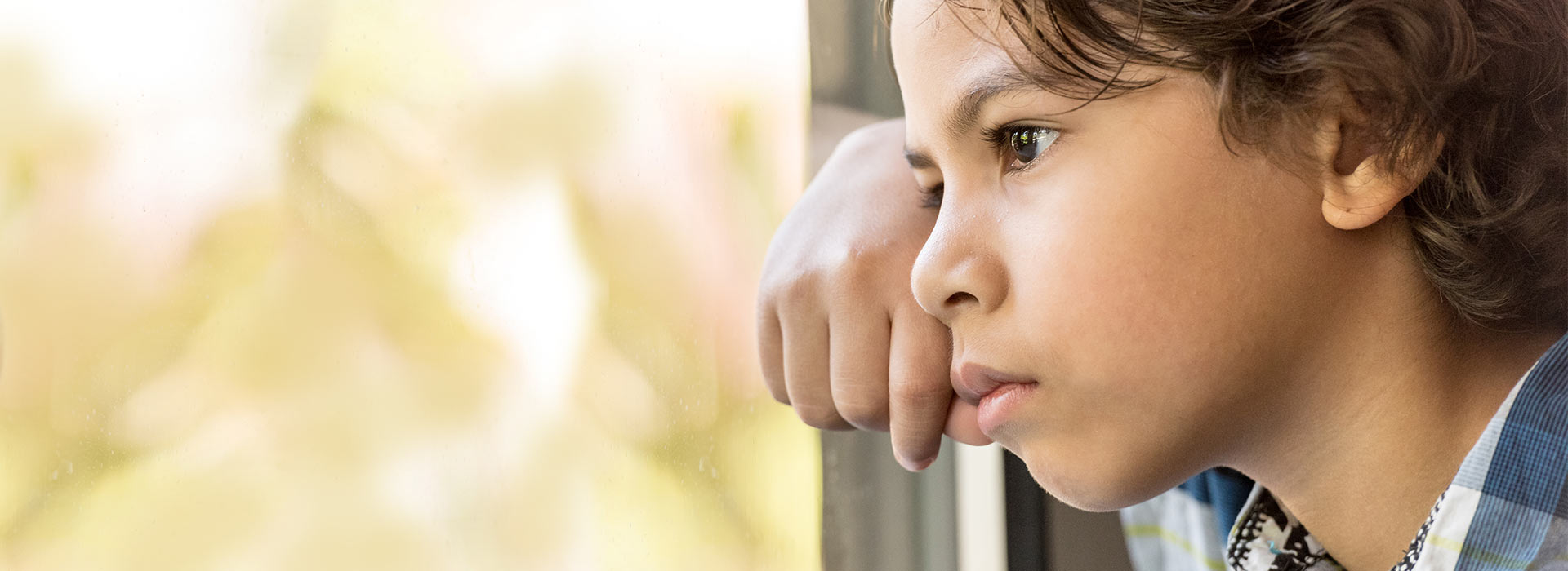 Anxious kid looking out the window